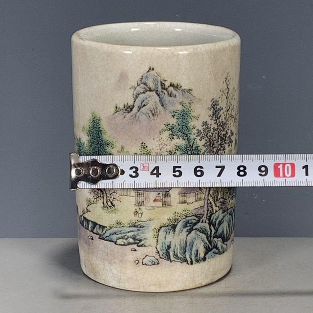 A charming Chinese porcelain brush pot (bitong). The cylindrical vessel features a creamy, all-over crackle glaze (Ge...