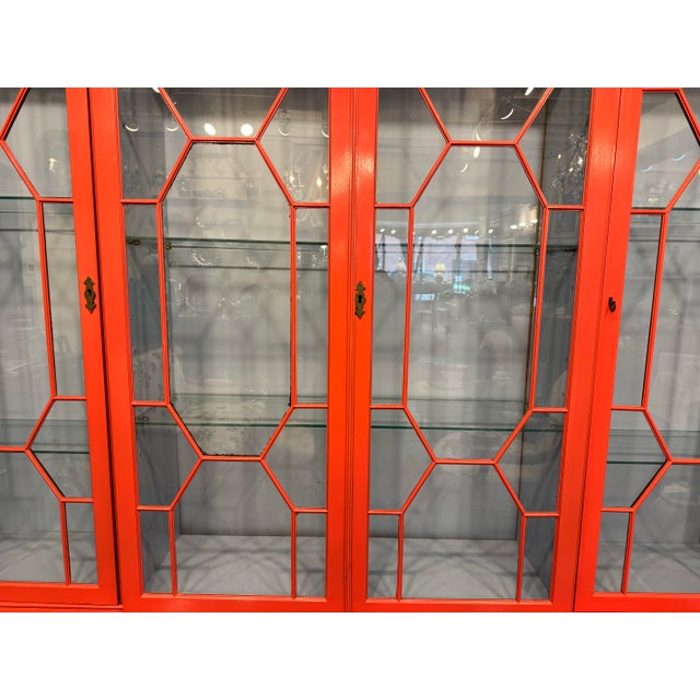 This is an antique glass cabinet. It is painted with stunning European tones of raspberry, and dusk blue. It has glass...