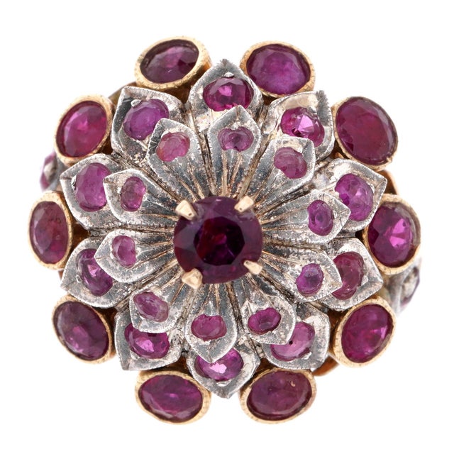 14K Gold and Ruby Cluster Cocktail Ring. White and Yellow gold floriform cluster band, center raised prong set round...