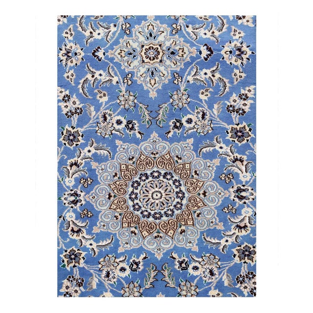 Persian Nain rugs are renowned for their detail and fine use of outlining along the central motifs. Breaking from the...