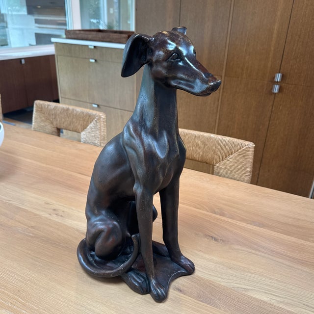 Vintage hand carved sculpture of a seated greyhound or whippet, breeds known for their elegance, speed and loyalty. This a...