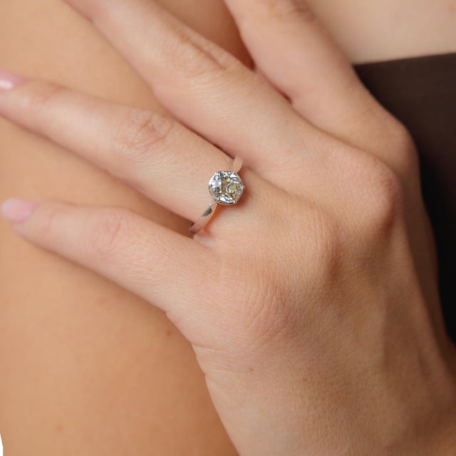 This striking Art Deco engagement ring centers on a beautiful 1.44 carat old mine cut diamond, certified by GIA...