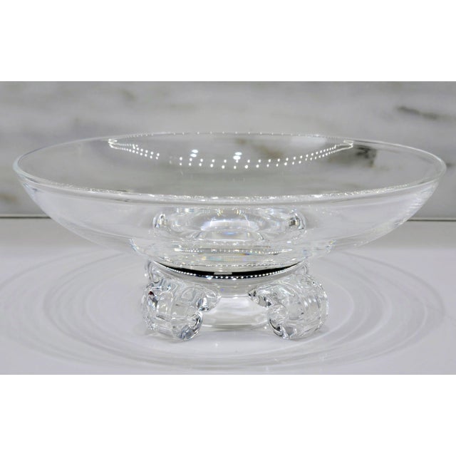 Signed Steuben clear crystal centerpiece bowl raised on an elegant footed base, beautifully catching and reflecting the...