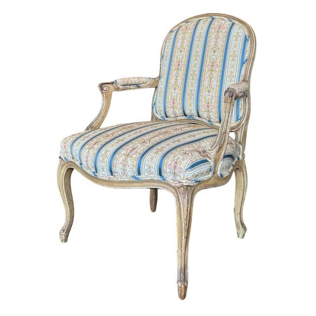 A graceful 18th-century Louis XV fauteuil, showcasing the elegance and comfort that define the French Rococo tradition....