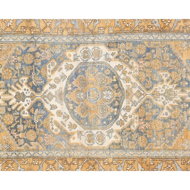 This semi-antique Melayer runner exemplifies traditional Persian craftsmanship, hand-woven with wool on a cotton...