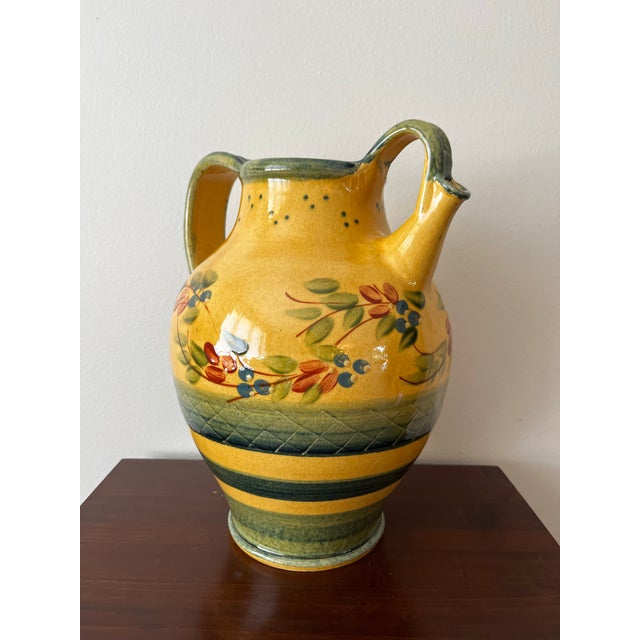 Beautiful vintage Terre è Provence hand-painted ceramic pitcher, made in France, featuring a warm golden ochre glazed body...