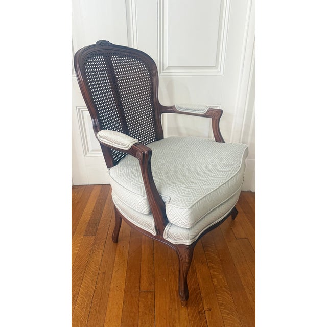 This elegant Louis XV–style bergère armchair was originally purchased through the Boston Design Center and reflects the...