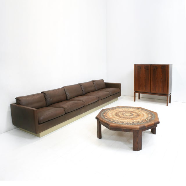 This artistic coffee table was designed by Ebbe Sørensen in the 1970s. It features embossed ceramic tiles in earth tones...
