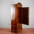 This impressive antique single-door wardrobe, dating back to the early 20th century, is a classic example of functional...
