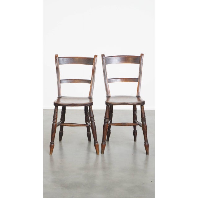 Offered this timelessly elegant set of 10 antique English Oxford dining/kitchen chairs with a warm color scheme. This...