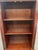 Bring the collected charm of an old-world library into your home with this tall apothecary-style display cabinet. A warm...