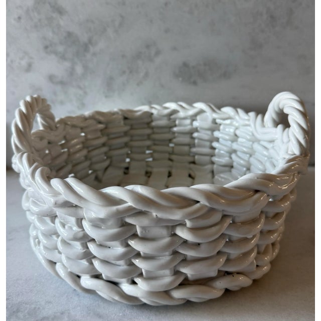 Large vintage Italian glazed ceramic woven basket with handles. Wonderful as a centerpiece for flowers or to hold fruit on...