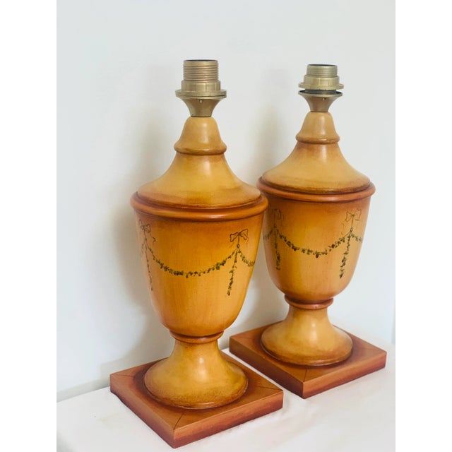 A pair of classic Italian, wooden table lamps. These are hand painted and hand decorated by renowned Dutch “House of...