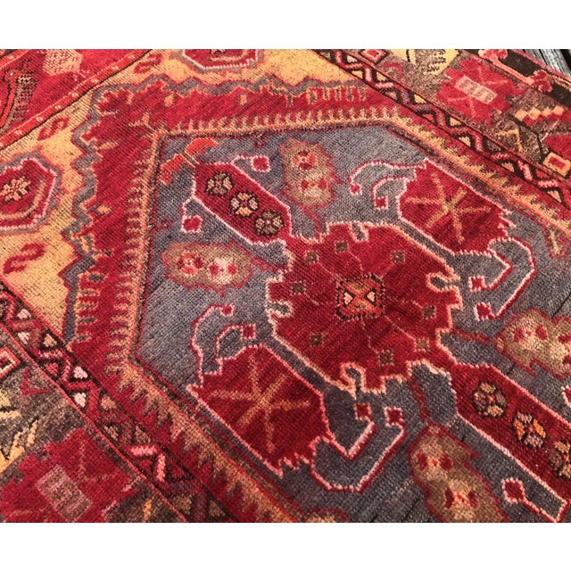 This vintage Turkish rug from the Cappadocia region of central Anatolia features a striking medallion design enriched with...