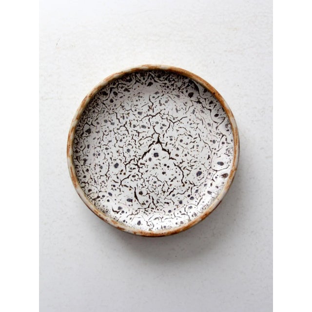 This hand-crafted studio pottery plate, signed by Jo Wiley and dating to circa 1976, features a stunning white crackled...