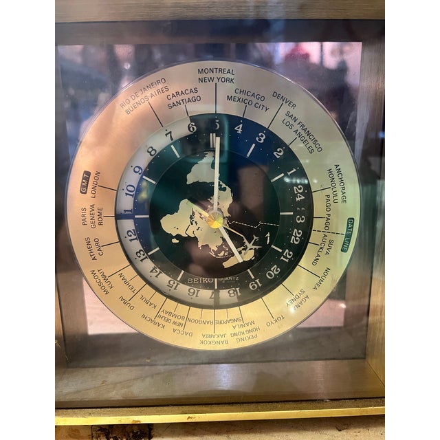 This vintage Seiko desk clock features a gold dial and shinny brass finish. It is a mid-20th century piece, manufactured...