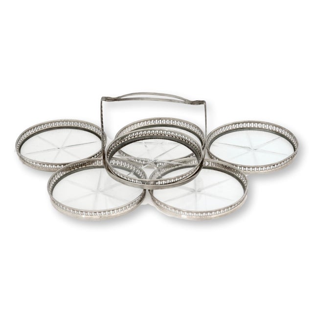 Early 20th-century American sterling-silver and cut-crystal coaster set with pierced rims and etched star centers. The...