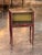 A slender side table of bedside form, decorated overall on a red ground with raised gilt chinoiserie. The galleried top...