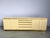 Luxurious seventies glamour sideboard by Jean claude Mahey consitsing of cream lacquer panels and brass. The use of...