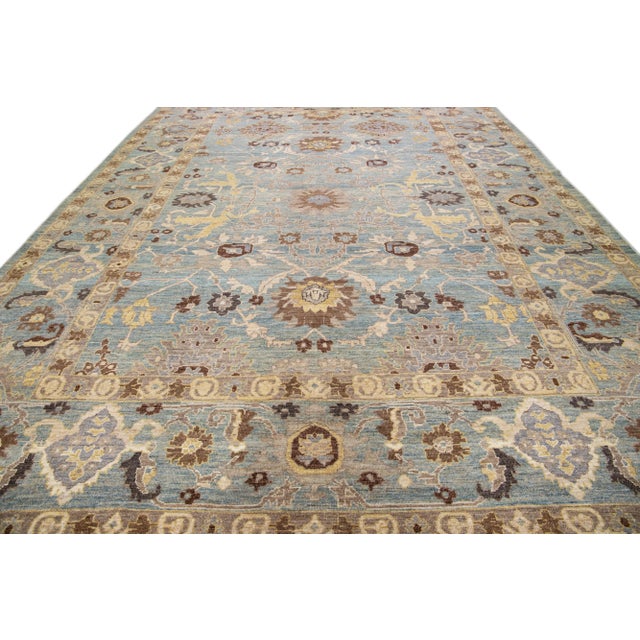 Beautiful modern Sultanabad hand-knotted wool rug with a blue field. This Sultanabad rug has brown, yellow, and beige...