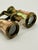 Elegant antique French opera glasses featuring luminous mother of pearl panels framed in richly patinated brass. A...