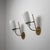 Pair of Italian wall sconces from the 1950s, combining green lacquered steel arms, brass details and softly diffusing...