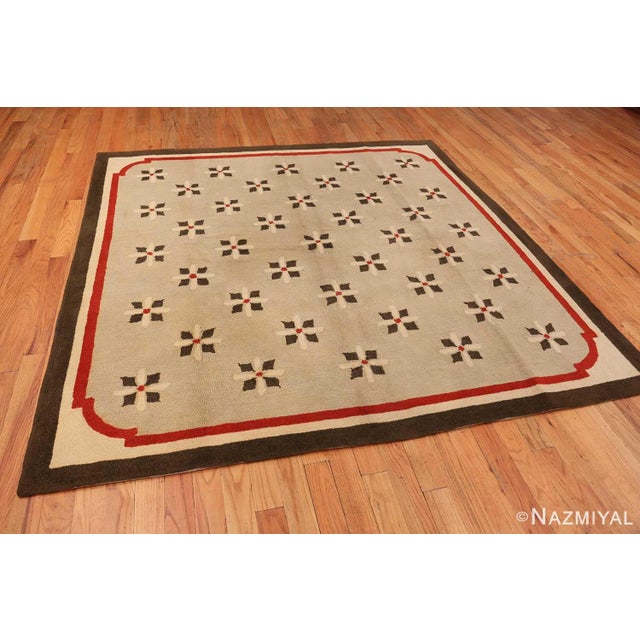 A square format carpet, this unique and intriguing composition is characterized by a pattern that includes thirty-right...