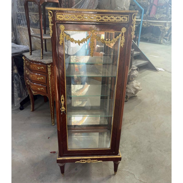 Bring classic European sophistication to your home with this grand French-inspired display vitrine. Crafted with a rich...