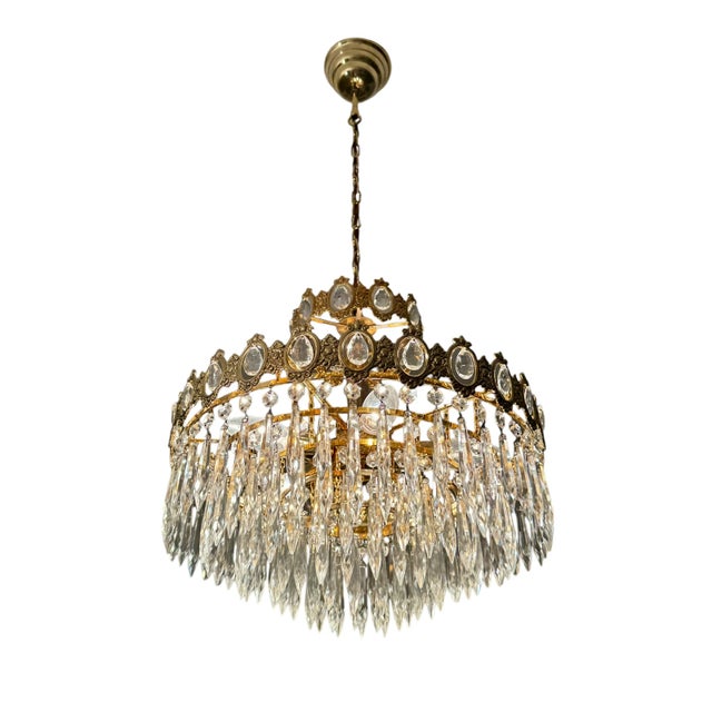 Mid-century French Empire style crystal chandelier, Europe circa 1950. Five tiered, gold plated metal filigree segments...