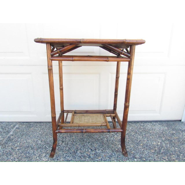 Antique English bamboo table, c.1900 A classic English bamboo table with a rectangular top with a lower shelf. All the...