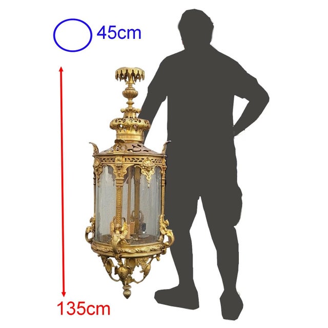Important cylindrical bronze lantern with a gilt patina and domed glass panes. It is richly decorated with palmettes,...
