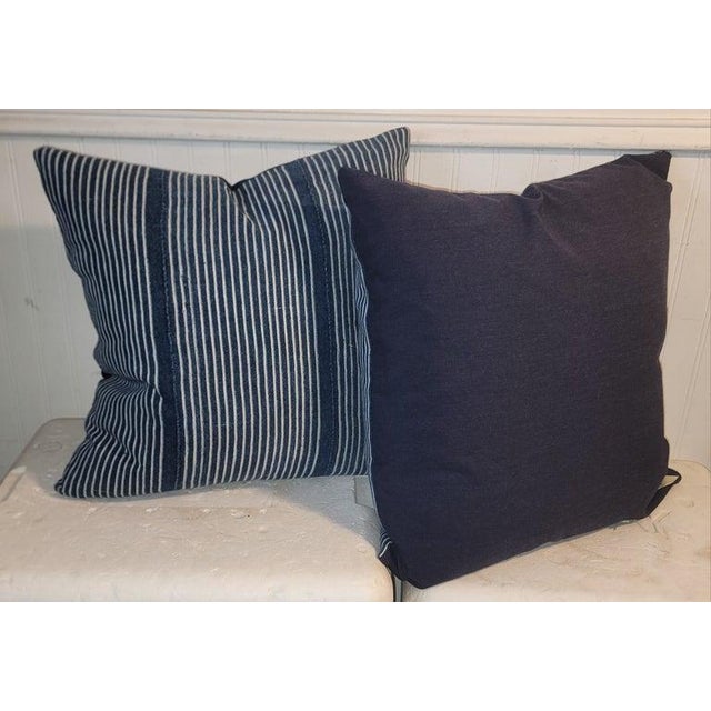 Blue and White Striped Linen Pillows with blue linen backing and a custom made down ad feather fill insert for cushion.