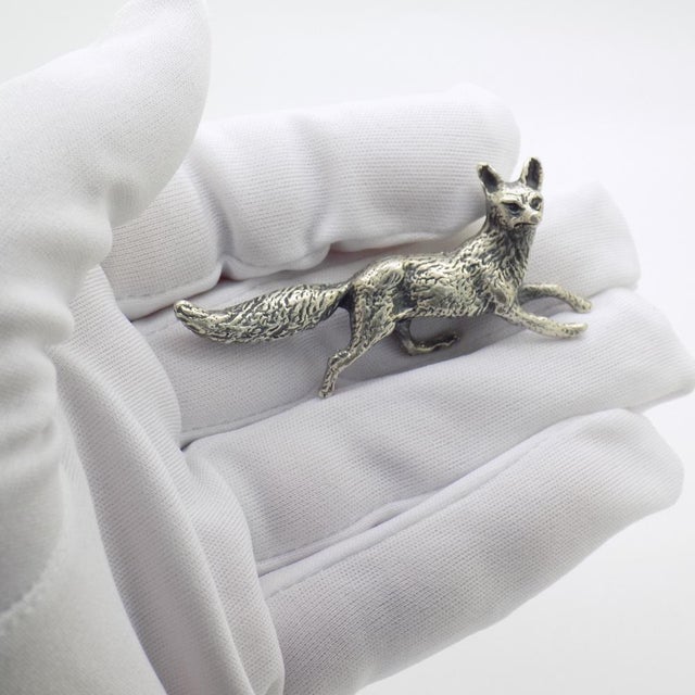 A vintage object depicting a miniature hunting fox, handcrafted in Arezzo, Italy between the 1970s and 1980s in authentic...
