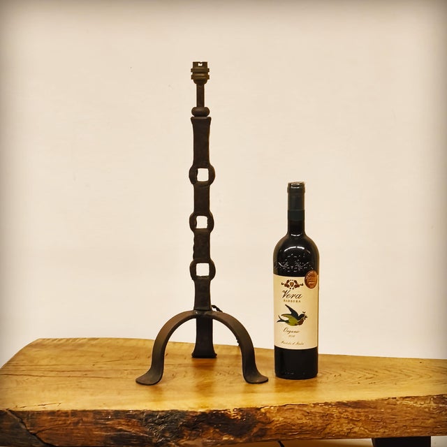 This French handcrafted lamp base features an openwork stem with three alcoves, resting on a base made of three curved and...