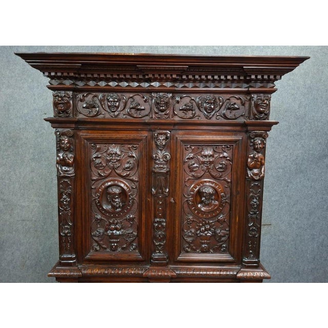 A richly carved walnut buffet/cabinet in the renaissance style, dating from the late 19th century. this spectacular piece...