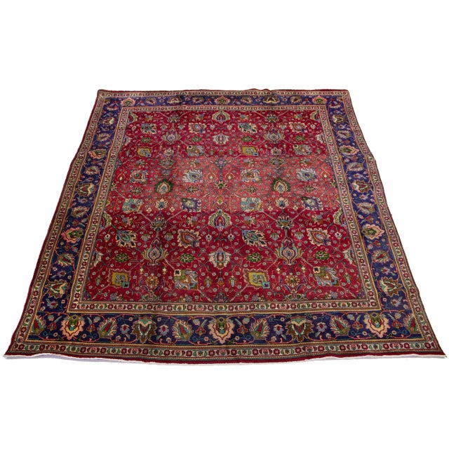 This beautiful hand-knotted Persian Tabriz wool rug features a vivid red field with multicolored accents throughout the...