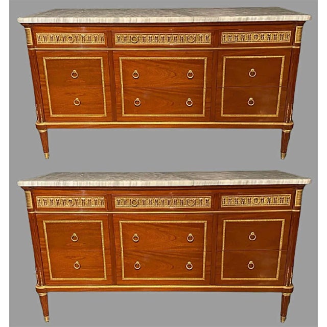 Pair of monumental Louis XVI style marble-top commodes in the Maison Jansen fashion. These impressive and finely...