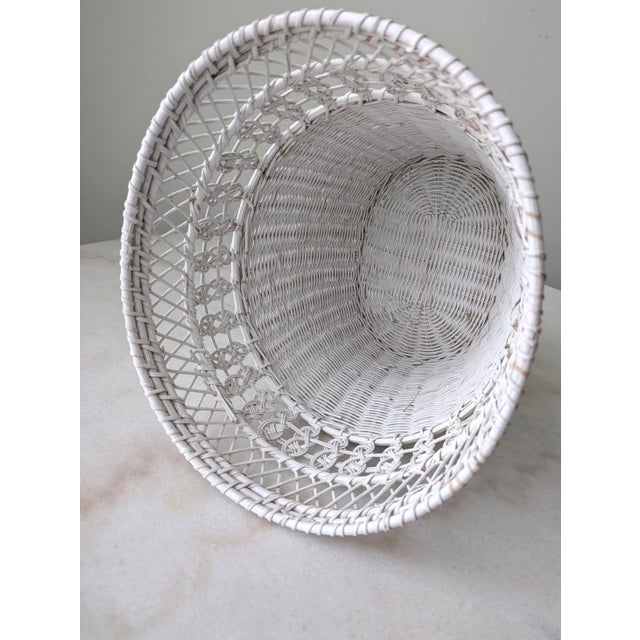 A vintage wicker wastebasket adds a charming and functional detail to any room.