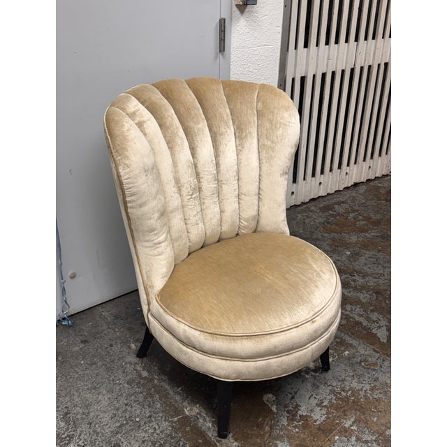 Design Plus Gallery presents a Vintage Art Deco Shell Slipper Chair. The curved back has a scalloped upper edge and padded...