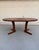 This extendable dining table by Dyrlund is a fine example of mid-century Danish craftsmanship, showcasing the beauty and...