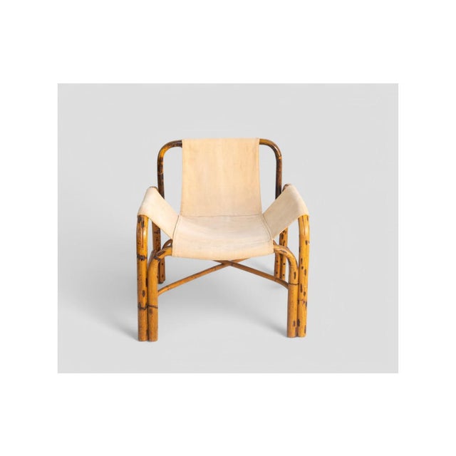 This charming 1960s vintage armchair embodies the essence of safari design with its curved bamboo frame and durable...