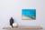 This artwork captures the serene beauty of a white sand beach, rendered in vibrant layers of resin that evoke the...