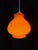 Elegant vintage pendant light in orange opaline, typical of 1970s design. Its curved shape and vibrant color add a pop of...