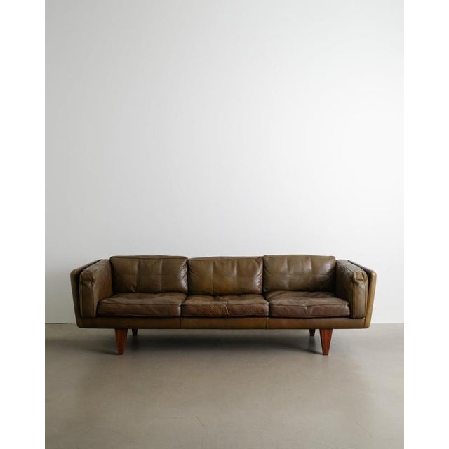 A rare danish mid century three seater sofa model "v11" in thick original olive brown leather with beautiful matching...