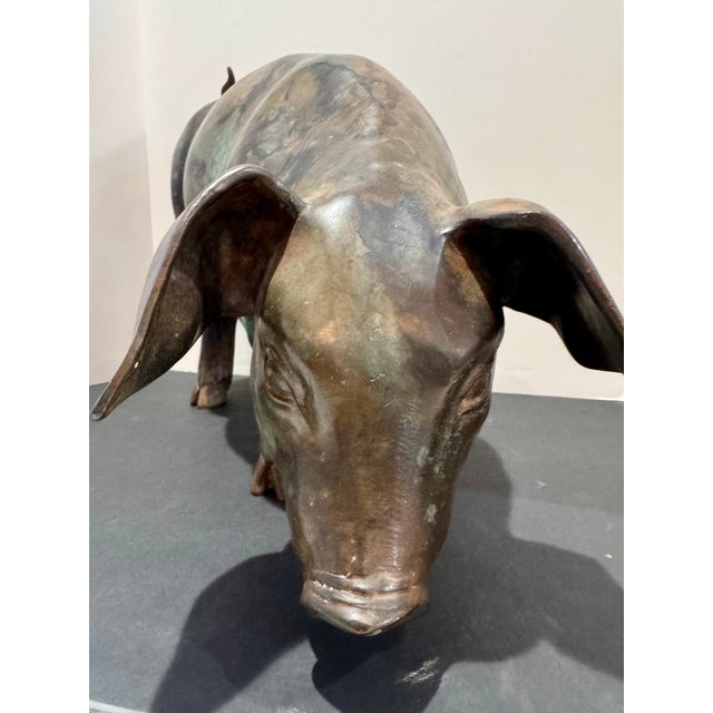 Large bronze pig sculpture in a grazing pose with beautiful natural patina and tonal variation. Material: Bronze Rich aged...