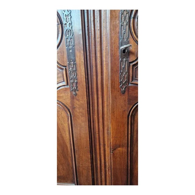 Provençal walnut wardrobe supported by wavy feet, on the front it has two paneled doors with carved and shaped frames....
