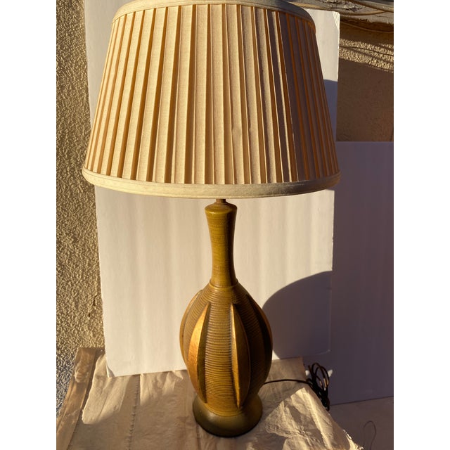 Mid Century lamp featuring a ribbed body and geometric form. Height: 19" base to socket, 25" w. shade If you just want the...