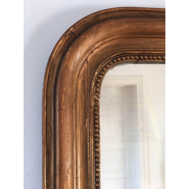 Antique French Louis Philippe mirror, dating to the late 19th century. The mirror features a giltwood frame with a warm,...