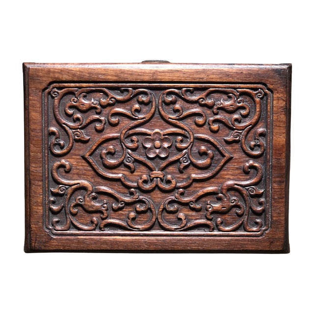Dating to the 1980s, this Huali wood jewelry box combines warm reddish-brown tones with decorative carving and a compact,...