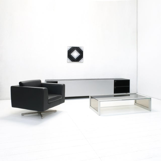 The Slide series were created in the late 1990s by Shigeru Uchida for Pastoe. This black sideboard features a silver...